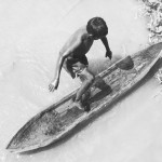 A Warao boy steps into his dugout canoe in Venezuela's Orinoco River Delta